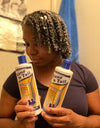 A women with 4C hair holding Mane 'n Tail 11.2 Ounce Repair 'n Replenish Shampoo, 11.2 Ounce Repair 'n Replenish Conditioner. She has the conditioner in her hair as a leave in.